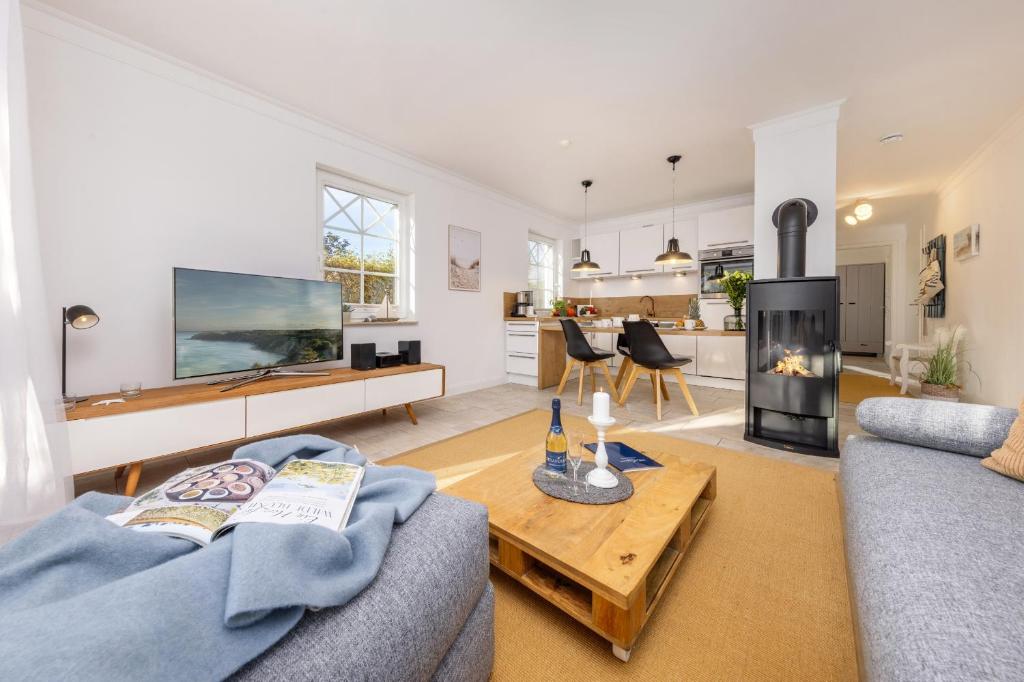 a living room with a couch and a table at Whg Dynamique in Zingst
