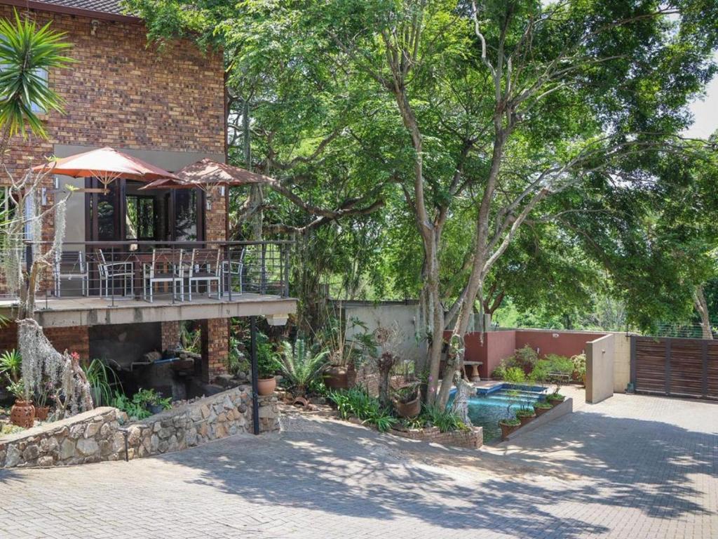 a house with a swimming pool and a patio at Willow Inn in Nelspruit