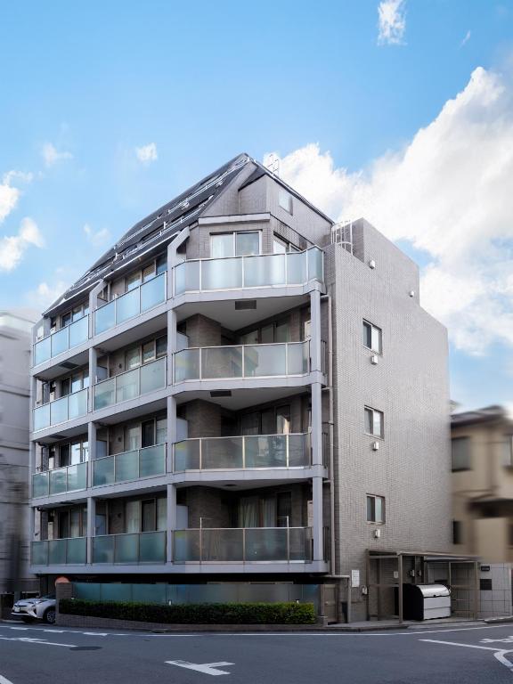 an apartment building with balconies on the side of a street at RARE-EBISU BREEZE Apartment in Tokyo