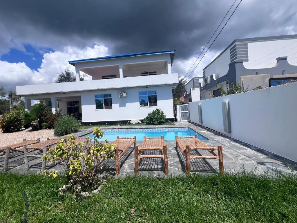 a villa with a swimming pool and a house at villa liam kiwengwa zanzibar in Kiwengwa
