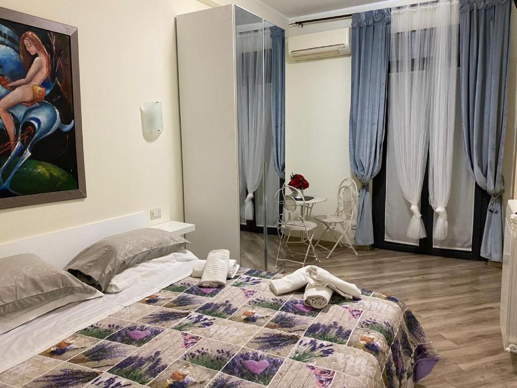 a bedroom with a bed with a quilt on it at Laviniahouse Nettuno in Nettuno