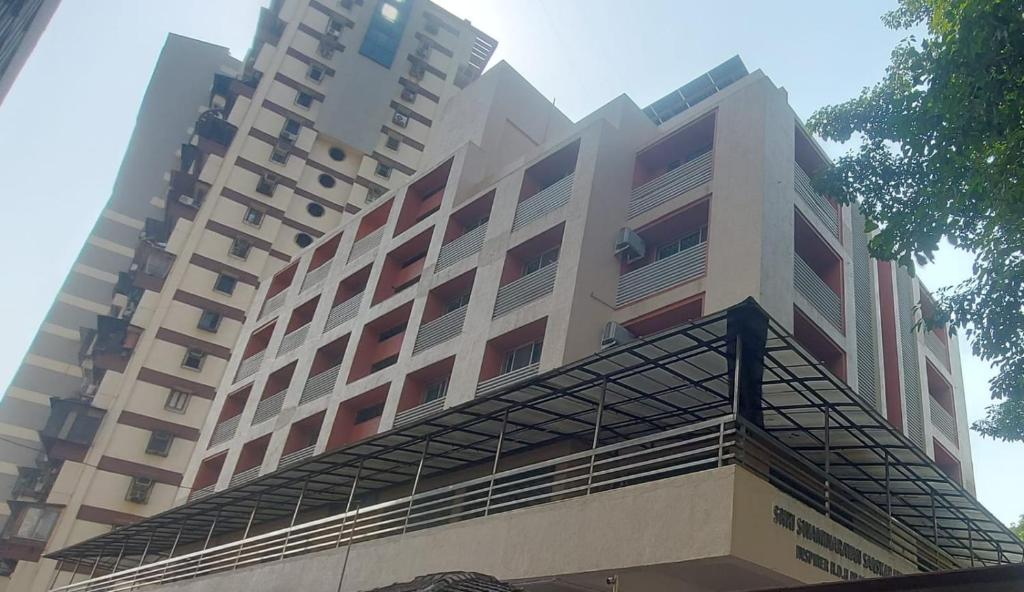 a large building with balconies on top of it at SATVIK STAy in Navi Mumbai