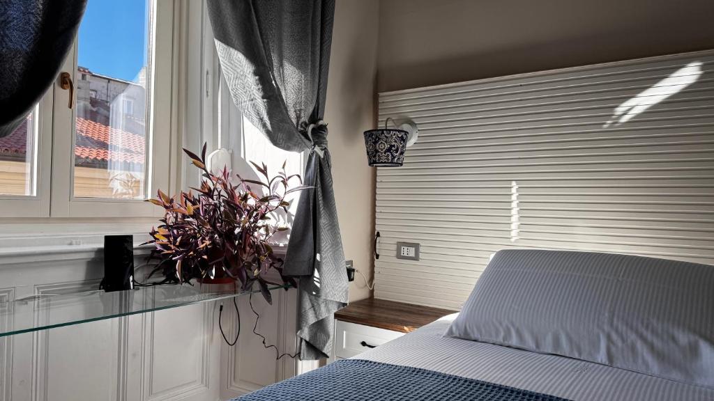 a bedroom with a bed and a window at Bed and Chic art rooms in Trieste