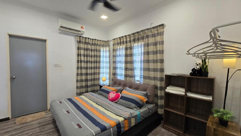 a bedroom with a bed and a window at Tuaran Village Guesthouse in Tuaran