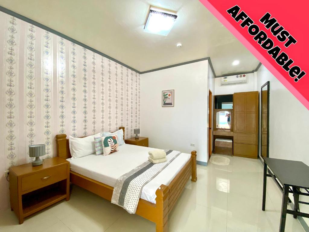a bedroom with a bed and a desk in it at ELEN INN - Malapascua Island Air-conditioned Room2 in Malapascua Island