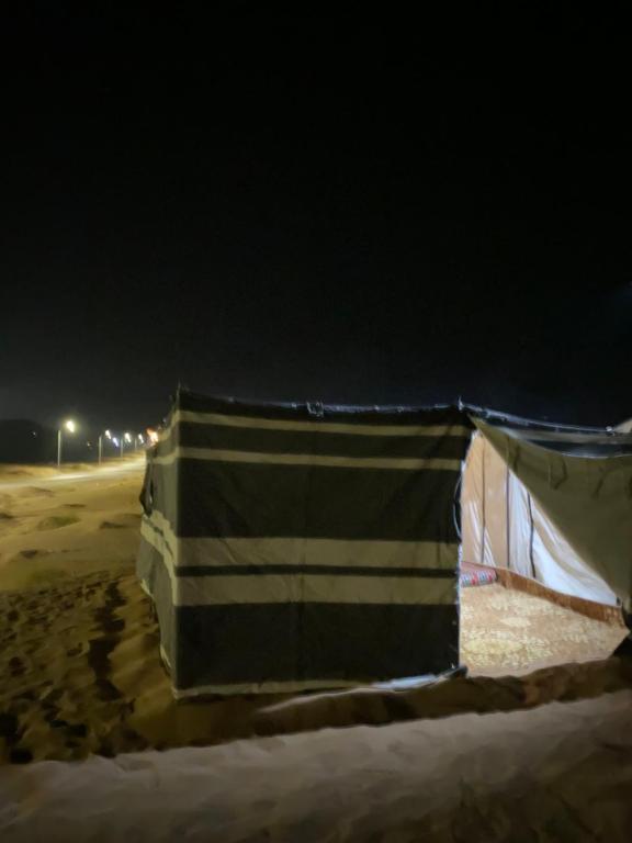 a tent on the beach in the snow at night at White nights in Bidiyah