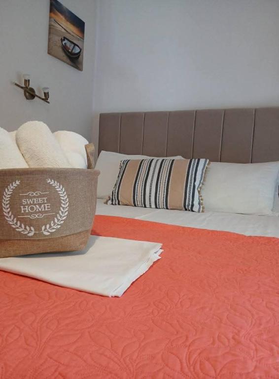 a bed with white sheets and pillows on it at Smaragdi Studios and Rooms in Agios Kirykos
