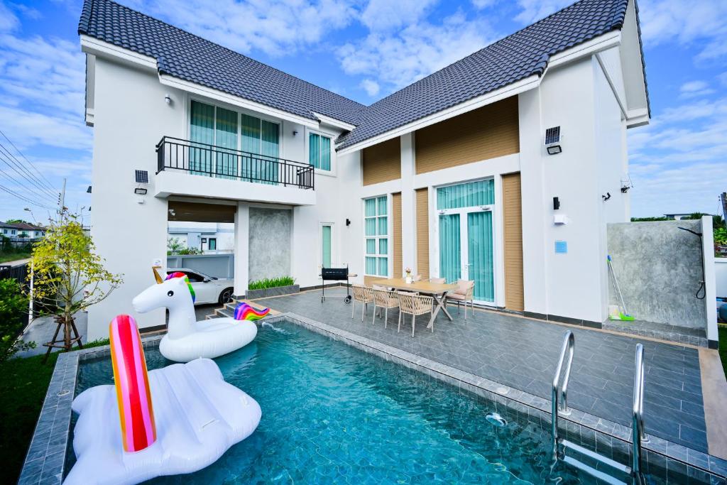 a house with a swimming pool with an inflatable pool toy at Santara Pool Villa Udon in Udon Thani
