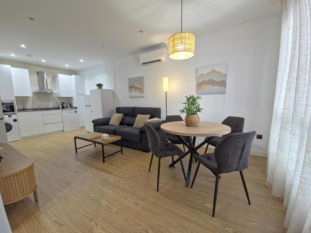 a living room with a table and a couch at Apartamentos Picasso by gaiarooms in Salamanca