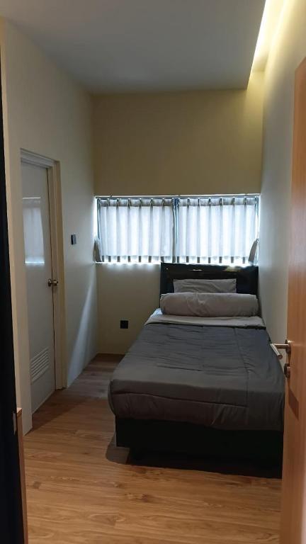 a bedroom with a bed in front of a window at First Kost Seturan 32 in Yogyakarta