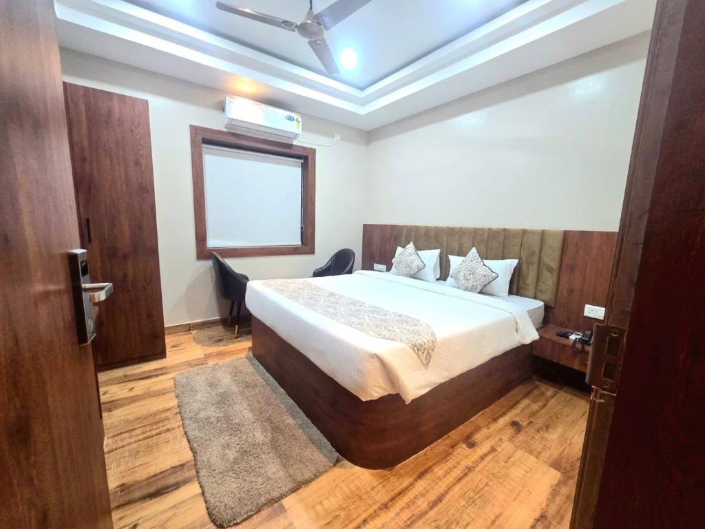 a bedroom with a bed and a window in it at Pratima Heritage in Bhubaneshwar