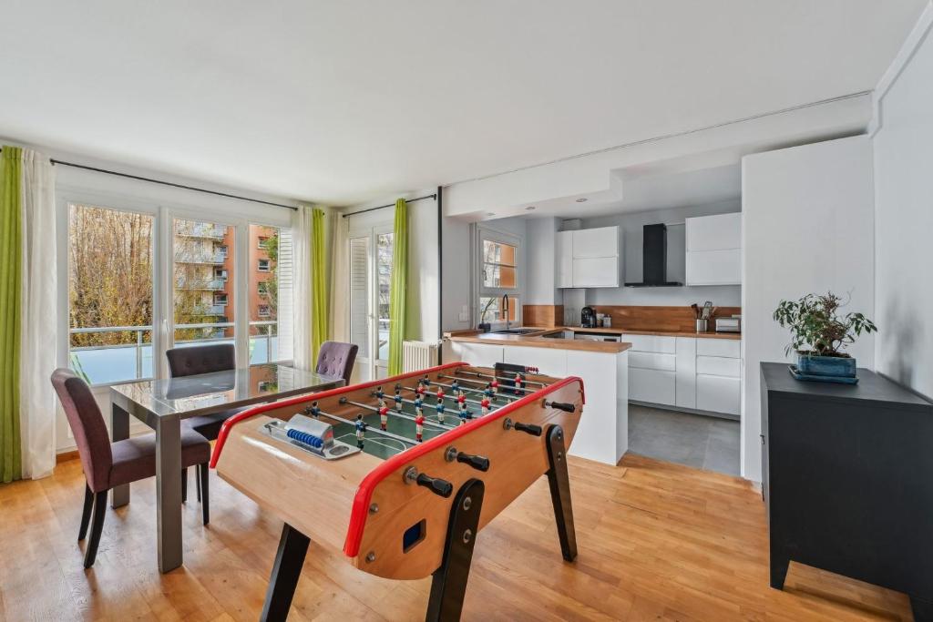 ein Wohnzimmer mit einer Tischtennisplatte in der Mitte in der Unterkunft Le Sportif - Montrouge in Montrouge