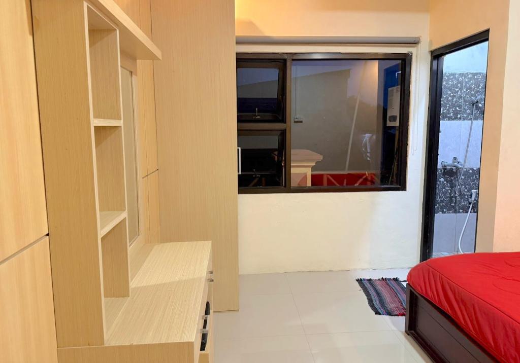 Un dormitorio con una cama y una ventana grande. en HR Hotel By Makati, en Batu