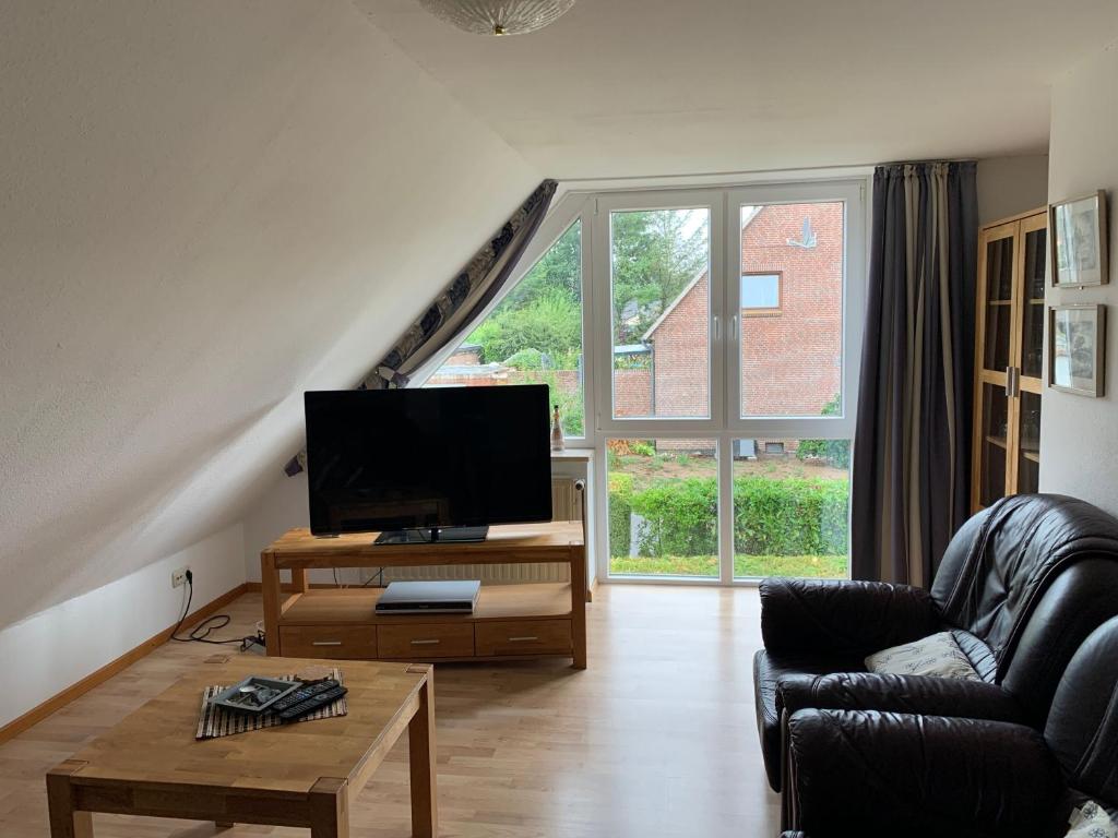 a living room with a large window and a television at Baltic Joy in Damp