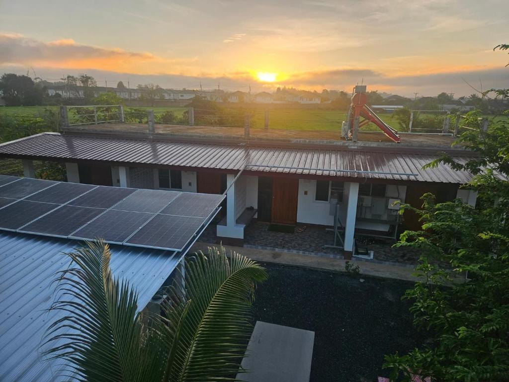 an image of a house with solar panels on the roof at Open Kitchen Chiang Rai in Chiang Rai