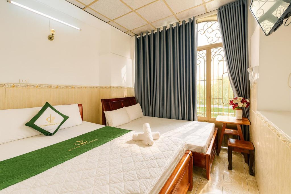 a bedroom with a bed with a stuffed animal on it at Thanh Long Hotel Hồ Chí Minh in Ho Chi Minh City