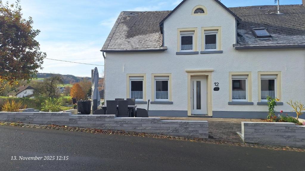 a white house on the side of a street at Feriendomizil-Vulkaneifel in Hillesheim