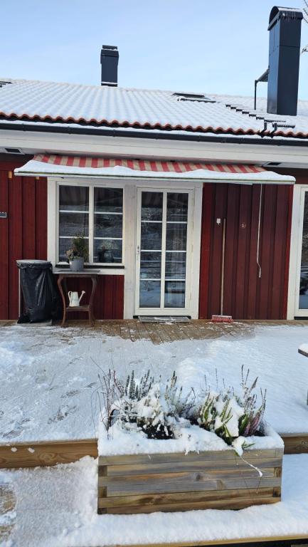 a house with snow on the ground in front of it at Studio Borgen in Sigtuna