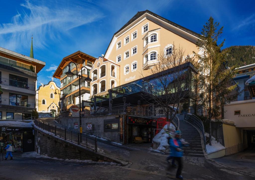 a group of people walking in front of a building at Hotel Goldener Adler - im Sommer Silvretta Card Premium inkludiert in Ischgl