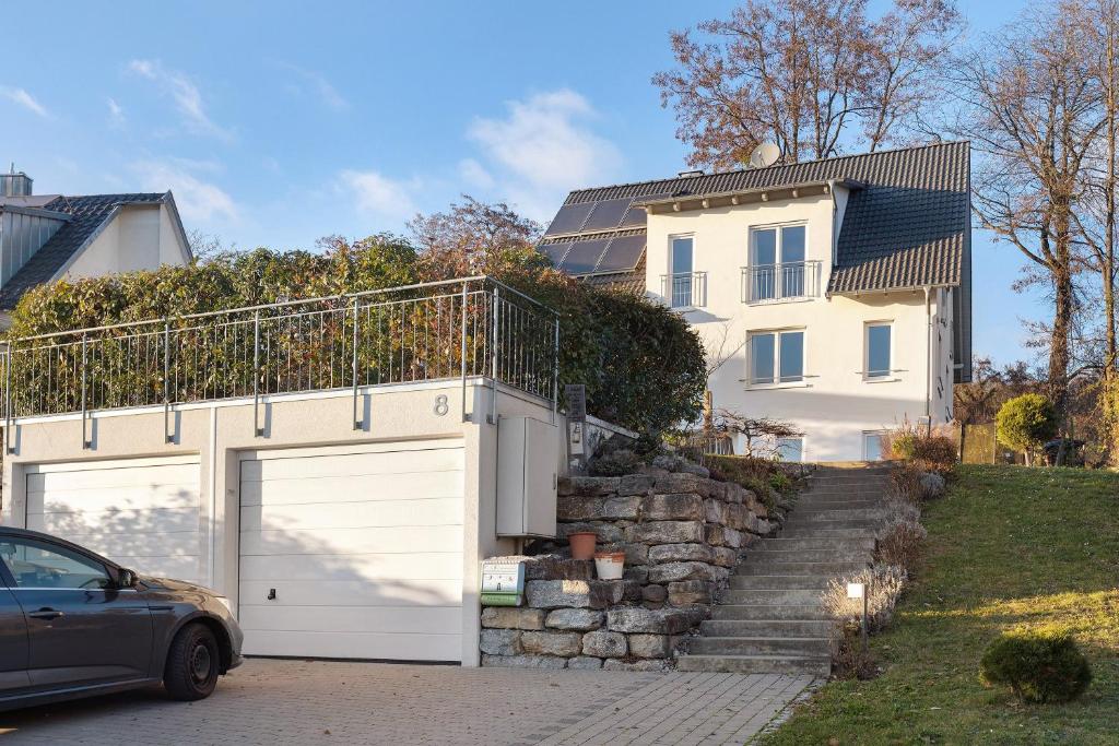ein Auto, das vor einem Haus mit Garage parkt in der Unterkunft Ferienwohnung Im Laubgarten in Öhningen