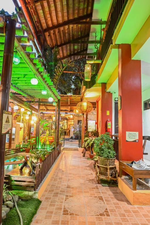 a building with a hallway with plants in it at Bulskamp Inn in El Nido