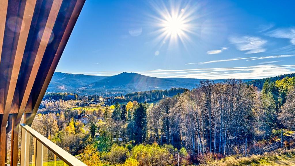 a view of the mountains from a deck of a house at Mountain Horizon Valley z basenami, saunami i strefą fitness by Royal Aparts in Szklarska Poręba