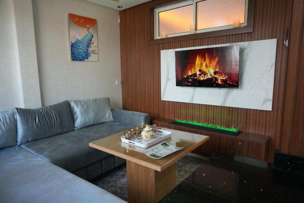 a living room with a couch and a fireplace at APPARTEMENT AMJAD iFRANE in Ifrane