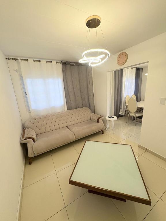 a living room with a couch and a table at GuestHouse16 in Kuito