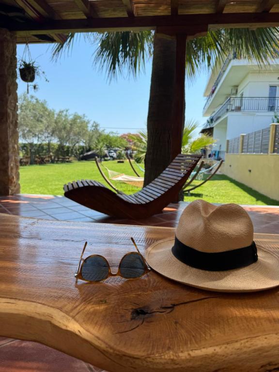 a hat and sunglasses sitting on top of a table at Maritsa's Rooms in Stavros