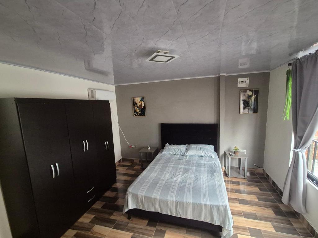 a bedroom with a large bed in a room at Medellín urban refuge in Medellín