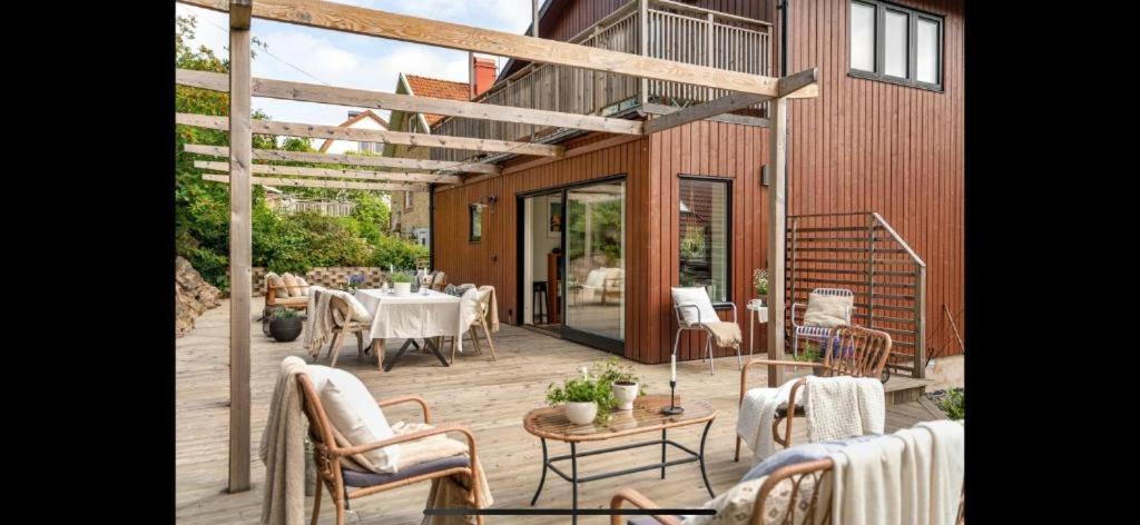 a patio with a table and chairs and a building at Beautiful house close to center in Gothenburg