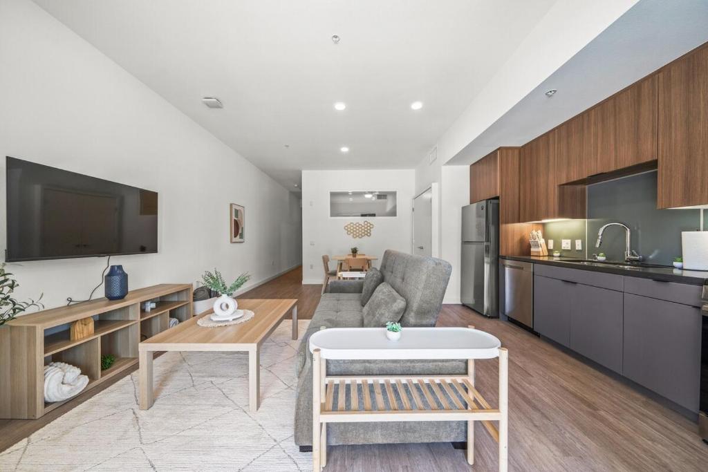 a kitchen and living room with a couch and a table at Stylish Condo Mins to Shoreline in Long Beach