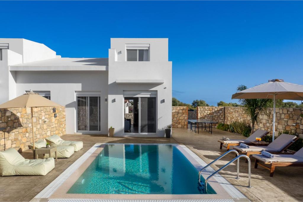 une villa avec piscine devant une maison dans l'établissement Amora Pool Villas, à Gennadi