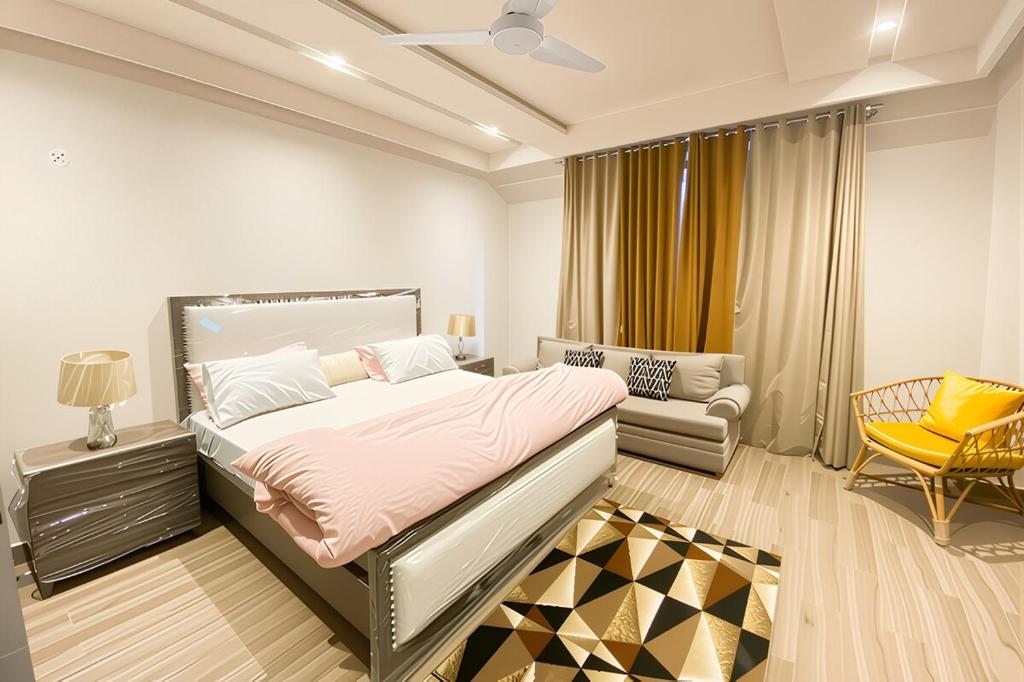 a bedroom with a large bed and a couch at Monal Murree Luxury Studio with Private Parking in Murree