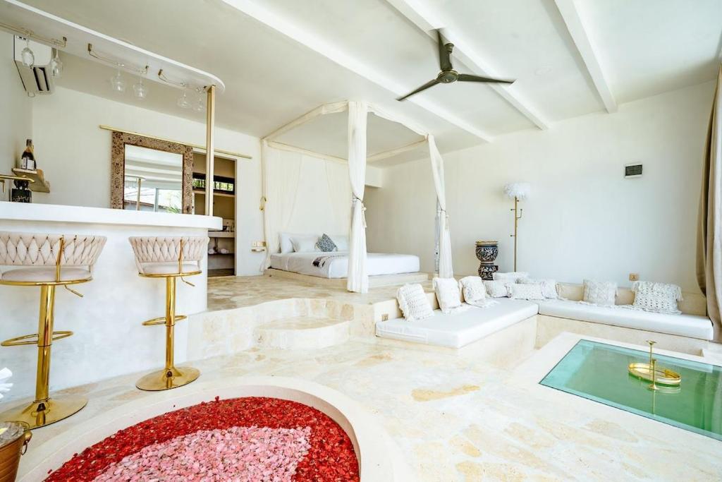 a large living room with a red rug on the floor at Sole 1BR Romantic Villa, 5 Min to Thomas Beach in Badung
