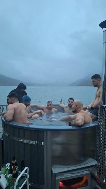 a group of men in a bath tub in the water at Casa belvedere orsova in Orşova