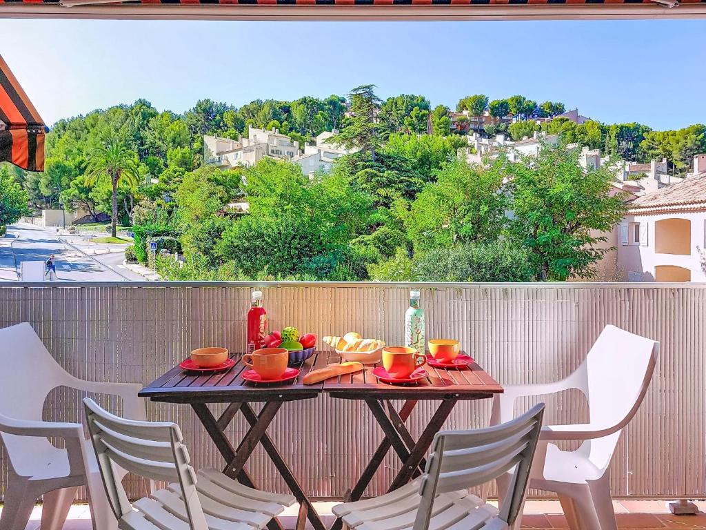 a table on a balcony with a table and chairs at Apartment Les Aigues Marines-36 by Interhome in La Madrague