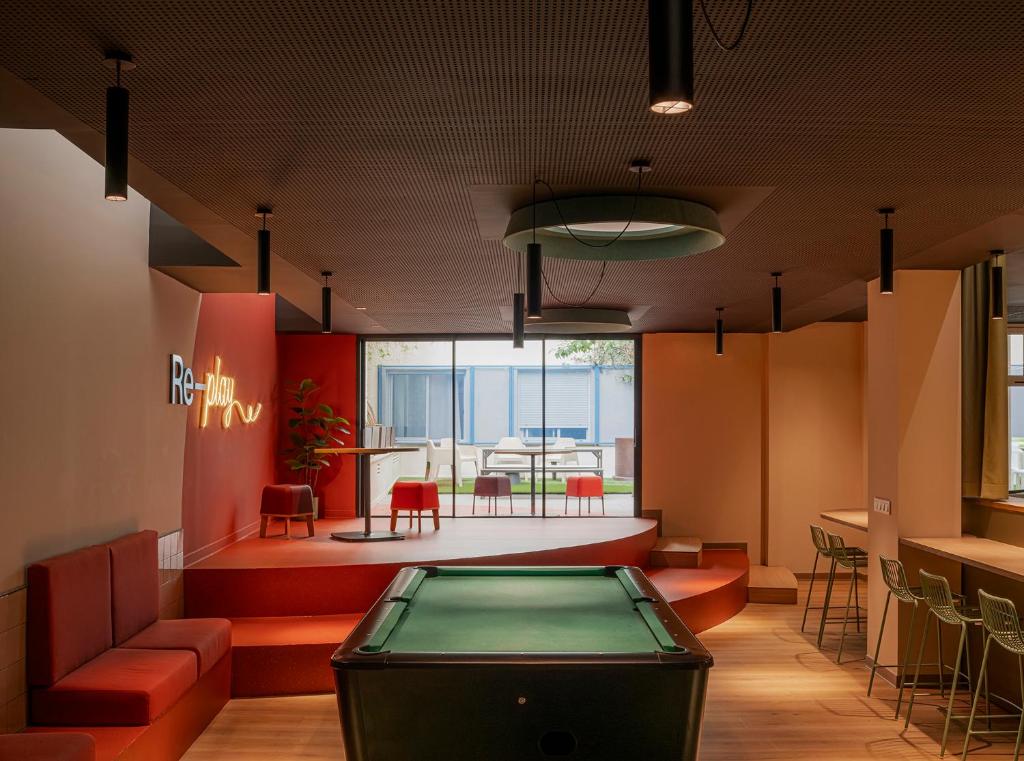 a ping pong table in a room with a table at Colegio Mayor Resa La Concepción in Valencia