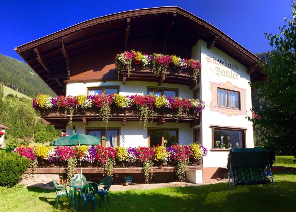 a building with flowers on the side of it at Gästehaus Danler in Neustift im Stubaital