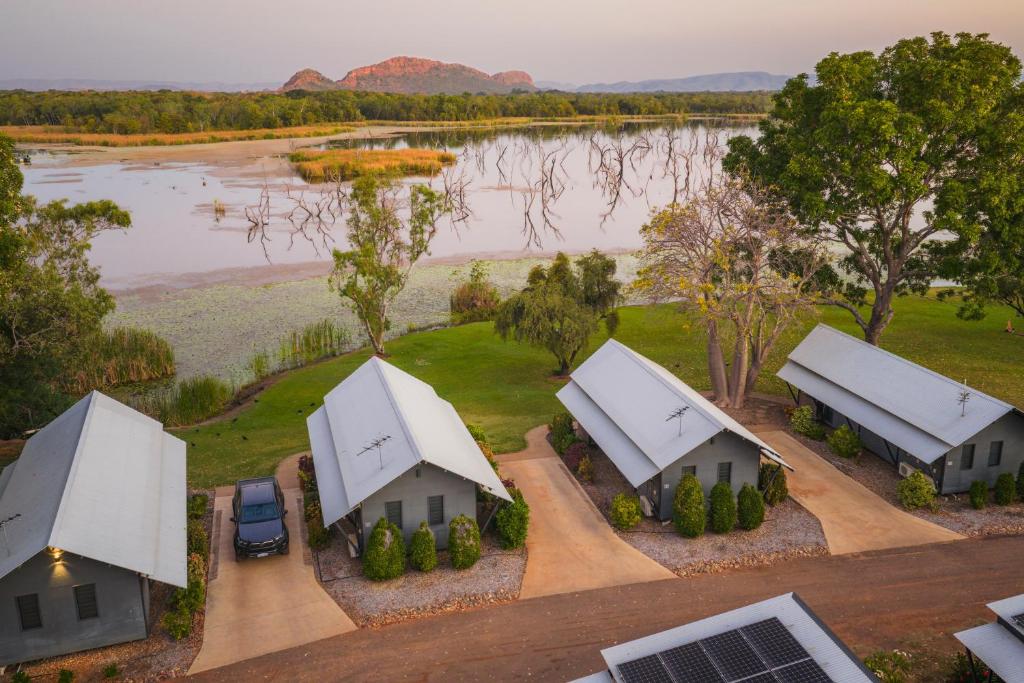 an aerial view of a farm with two white buildings at Kimberleyland Waterfront Holiday Park in Kununurra