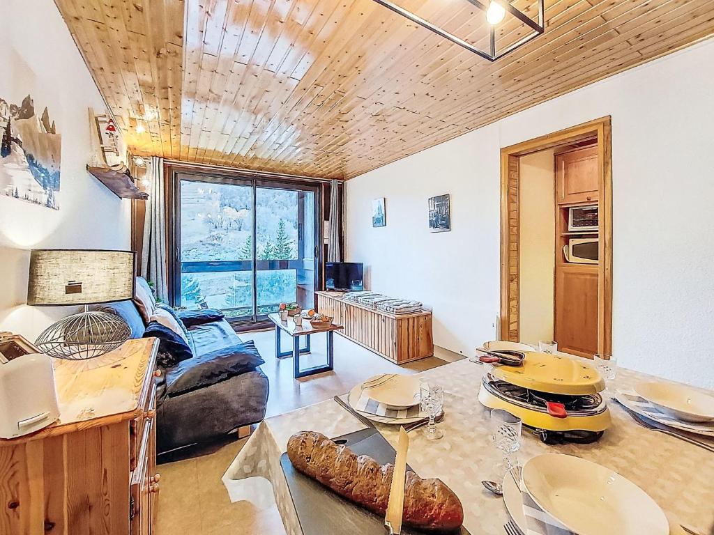 a living room with a couch and a table at Apartment Pegase Phenix-74 by Interhome in Le Corbier