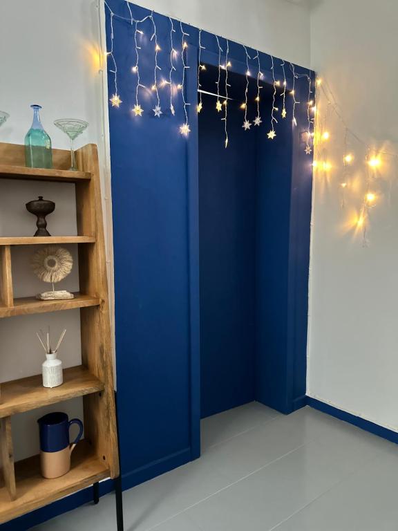 a blue room with a blue door and lights at Casa Rara al Mare in Monopoli