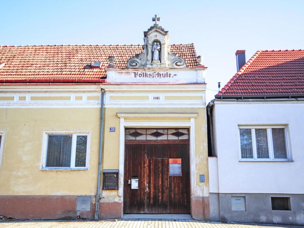 a building with a wooden door in a city at Studio Ysella by Interhome in Raiding
