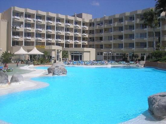 a large pool with blue water in front of a hotel at Casa LuLu in San Miguel de Abona