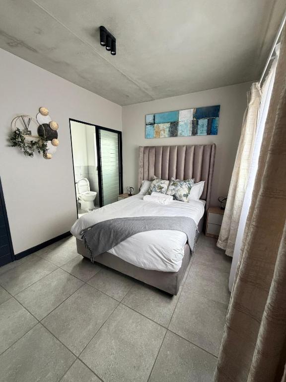a bedroom with a large bed in a room at Sunset Sucasa in Midrand