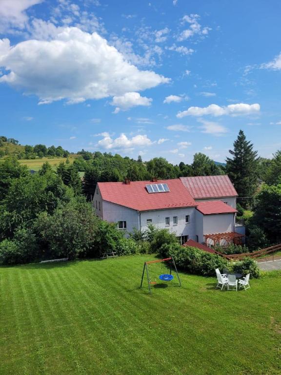 a house with a yard with two chairs and a playground at Dom nad potokiem Opawa, na wyłączność, Karpacz, Opawa in Opawa