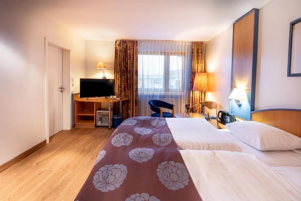 Postel nebo postele na pokoji v ubytování Hotel Karl