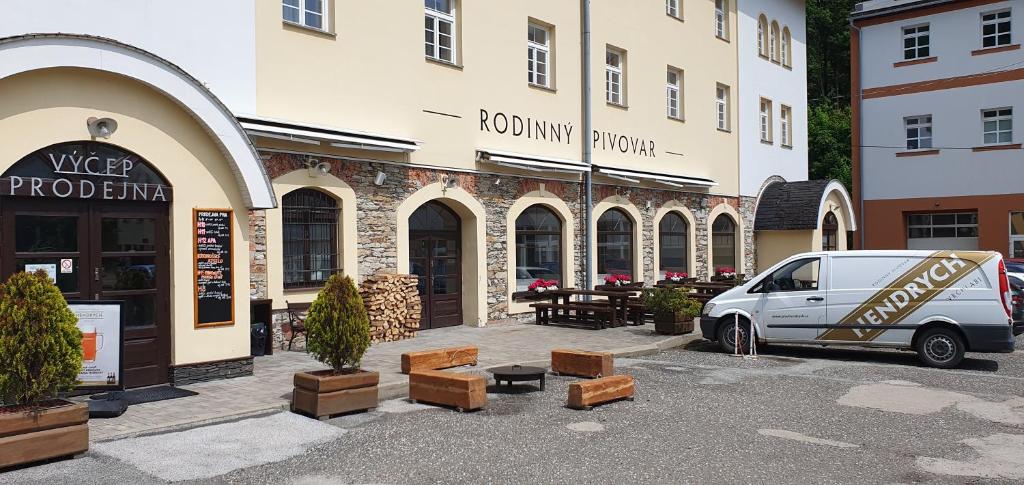 a white van parked in front of a building at Penzion Hendrych in Vrchlabí