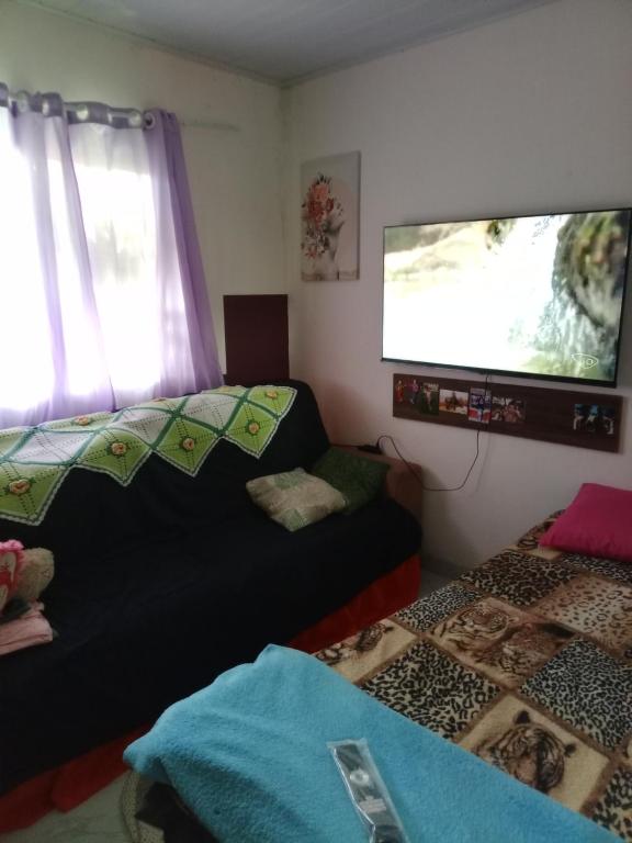 Ένα ή περισσότερα κρεβάτια σε δωμάτιο στο Recanto Beija-flor