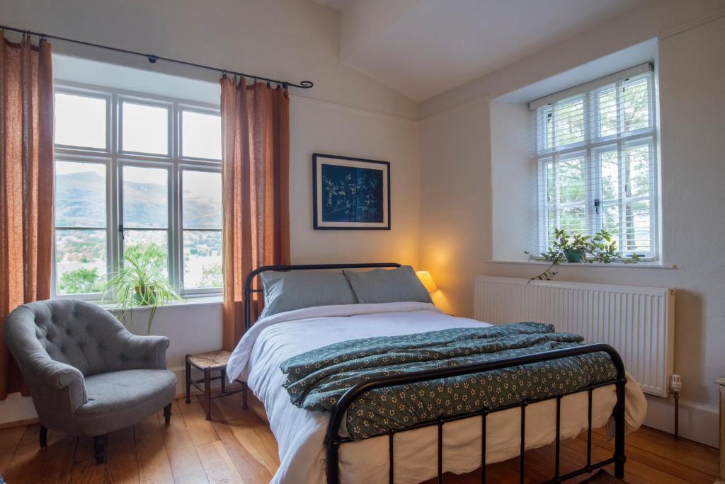 En eller flere senge i et værelse på The Coachmans Quarters